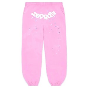 May include: Pink sweatpants with the word "spogds" in white script across the top. The pants have a drawstring waist and are decorated with small blue and white speckles. The bottoms are cuffed.