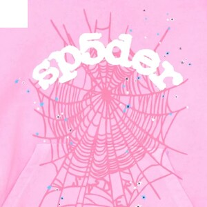 May include: Pink hoodie with a spiderweb design and the word "sp5der" in white. The spiderweb is a lighter shade of pink, and there are small blue and white star-shaped accents scattered around the design.