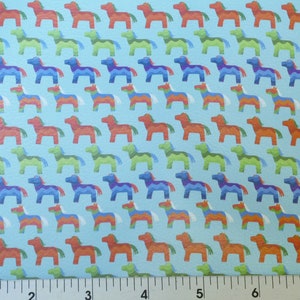 May include: Light blue fabric with a repeating pattern of colorful, stylized horses. The horses are in shades of red, orange, green, and blue, with white accents. The pattern is evenly spaced across the fabric.