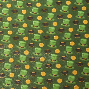 May include: A green background featuring a repeating pattern of green leprechaun hats, gold coins, and black pots of gold. The hats have a gold buckle and the coins are round. The pattern is a St. Patrick's Day theme.