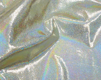 May include: Close-up of iridescent silver fabric with a textured surface. The fabric has a subtle shimmer and a slightly wrinkled appearance.