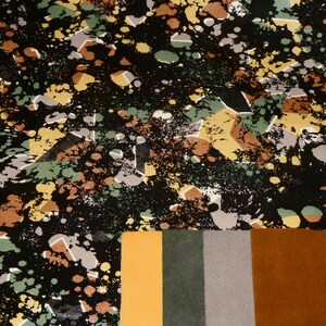 May include: A black fabric with a colorful abstract print of geometric shapes and splattered paint. The fabric is shown next to four fabric swatches in orange, green, gray, and brown.
