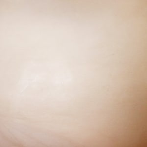 May include: A plain, off-white background with a subtle, textured surface.