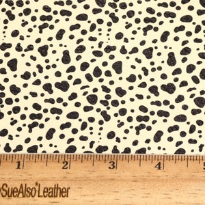 May include: Close-up of a cream-colored fabric with a black dalmatian spot pattern. A ruler is placed at the bottom of the image with the text "PeggySueAlsoLeather" visible.