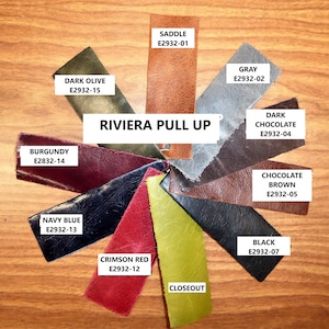 May include: A collection of Riviera Pull Up leather swatches arranged in a circular fan pattern. Colors include saddle, gray, dark chocolate, chocolate brown, black, closeout, crimson red, navy blue, burgundy, and dark olive, each with a label.