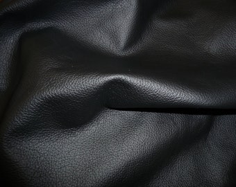 May include: Close-up of black leather with a pebbled texture.