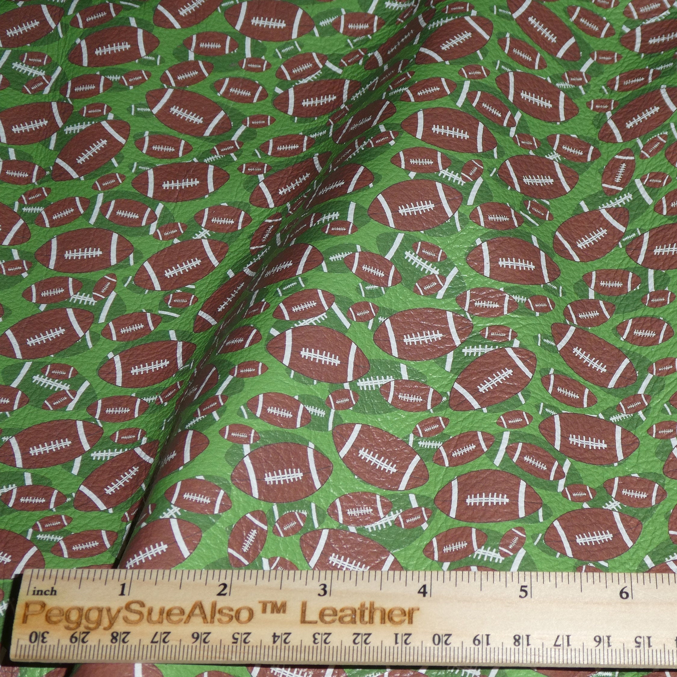 Leather 12x12 FOOTBALLS on GREEN (largest footballs are 1.25 across