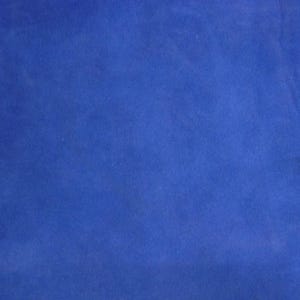 May include: A close-up shot of a solid blue fabric. The fabric has a soft, velvety texture and a rich, deep blue color. The lighting creates subtle variations in the color, highlighting the texture.