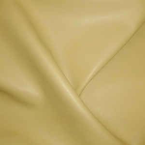 May include: A close-up of a smooth, pale yellow fabric with a subtle texture. The fabric is folded in a way that creates a V-shape.