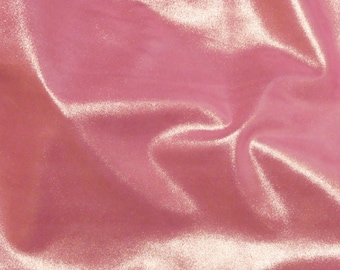 May include: A close-up of a soft, pink velvet fabric with a subtle shimmer. The fabric is smooth and has a luxurious feel.