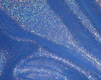 May include: Close-up of a vibrant blue fabric with a shimmering, glittery texture. The material has a flowing, draped appearance, with subtle folds and highlights. The surface sparkles with iridescent flecks, creating a dynamic and eye-catching effect.