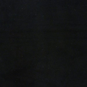 May include: A solid black fabric, possibly felt or a similar material, is displayed. The fabric is rectangular and appears to be lying flat. The texture is slightly visible, and the color is a deep, consistent black.