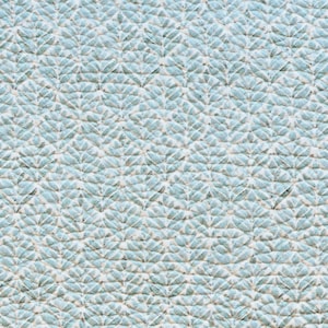May include: A close-up of a light blue fabric with a white and light blue patterned design. The pattern is a repeating design of small leaves.