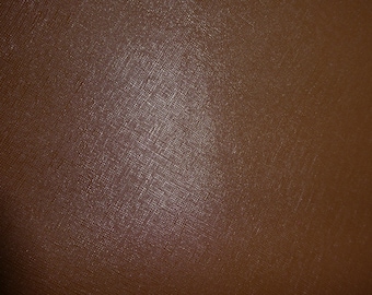 May include: Close-up of a brown textured leather surface.