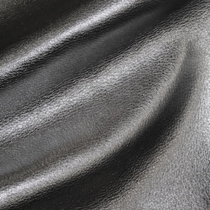 May include: Close-up of a black leather fabric with a textured surface.