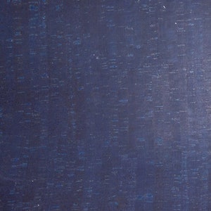 May include: A close-up of a dark blue corkboard surface with a fine, speckled texture.