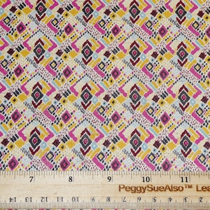 May include: A close-up of a fabric with a geometric pattern in shades of pink, yellow, blue, and gray. The fabric is measured with a ruler that reads "PeggySueAlso™ Leather".