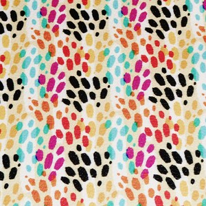 May include: A vibrant fabric design with a repeating pattern of oval shapes in multiple colours. The pattern incorporates black, red, pink, orange, yellow, and teal shapes on a cream background. The design is abstract and visually appealing.