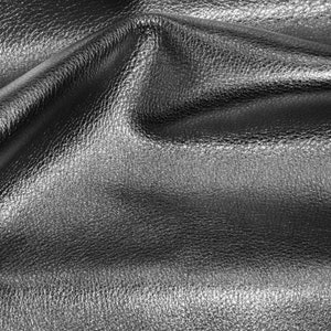 May include: Close-up of a silver leather fabric with a textured surface. The fabric is folded and draped, creating soft folds and wrinkles.
