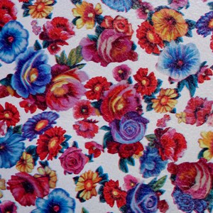 May include: A white background with a colorful floral pattern. The flowers are in shades of red, pink, blue, yellow, and purple. The flowers are arranged in a random pattern.