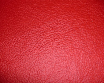 May include: Close-up of a red textured leather surface.