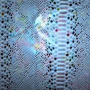 May include: A close-up of a white snakeskin fabric with a subtle iridescent sheen. The fabric has a textured pattern that resembles scales.