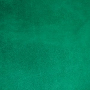 May include: A solid green background with a slightly textured surface.