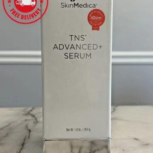 May include: A white rectangular SkinMedica TNS Advanced+ Serum box with black text, a silver base, and a red Allure Best of Beauty Hall of Fame seal. The packaging displays the net weight as 1.0 oz. / 28.4 g on the front lower portion of the box.