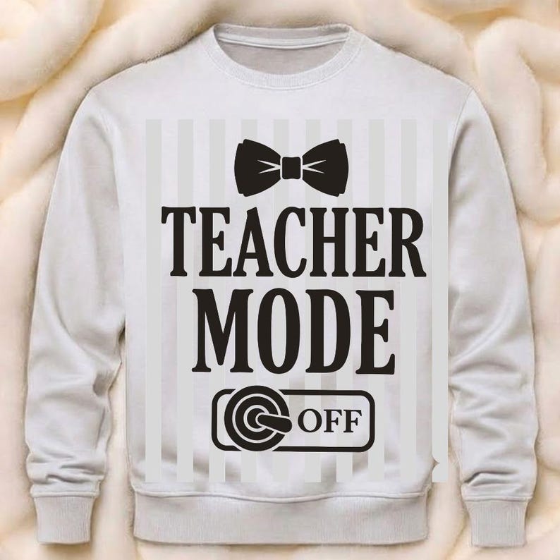 May include: White sweatshirt featuring a black bow tie graphic and the words "TEACHER MODE OFF" in black. The design includes a striped background. A casual, comfortable garment for teachers.