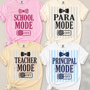 May include: Four short-sleeved t-shirts in pink, cream, tan, and white. Each shirt features a bow tie graphic and the words "SCHOOL MODE", "PARA MODE", "TEACHER MODE", and "PRINCIPAL MODE" in bold letters. The shirts have a casual, knotted style.