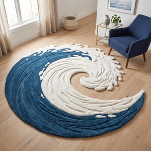 May include: A circular area rug featuring a large, stylised ocean wave design. The rug is primarily deep blue with thick, raised white sections representing sea foam and the crest of the wave, creating a textured, layered appearance on the floor.