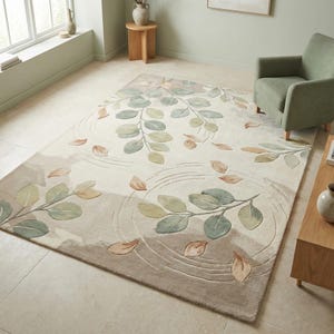 May include: A rectangular rug with a botanical design. The rug has a cream base with a pattern of green and tan leaves and petals. The leaves are arranged in a flowing pattern, creating a sense of movement. The rug would suit a living room.