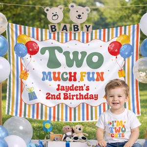 May include: A child's second birthday party scene. A banner reads "Two Much Fun, Jayden's 2nd Birthday." The child wears a shirt that says "I'm Two Cute." Balloons in blue, white, gold, and red decorate the scene. Wooden bear cutouts spell "BABY."
