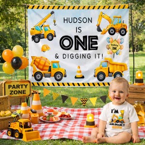 May include: A birthday party scene with a banner that reads "HUDSON IS ONE & DIGGING IT!" and features construction vehicles. A child wears a shirt that says "I'M AND DIGGIN IT HUDSON". Balloons, a picnic, and a "PARTY ZONE" sign are also visible.
