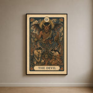May include: A rectangular wall art print featuring a tarot card design titled THE DEVIL with the Roman numeral XV. The illustration depicts a horned, winged demon figure looming over two kneeling figures, all rendered in a dark, muted color palette.