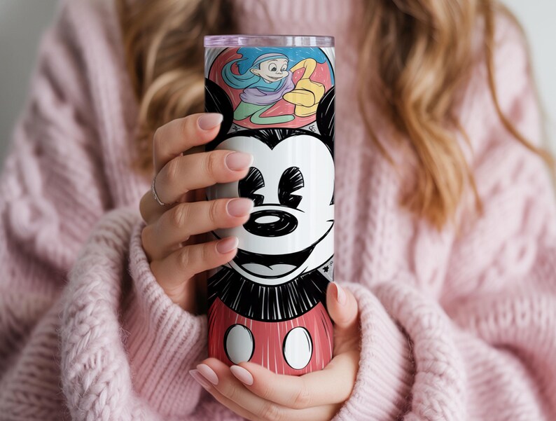 May include: A tall, insulated tumbler featuring a smiling Mickey Mouse design. The tumbler has a red, black, and white color scheme with a cartoon illustration of Mickey Mouse's face and body. The top section has a colorful cartoon illustration.