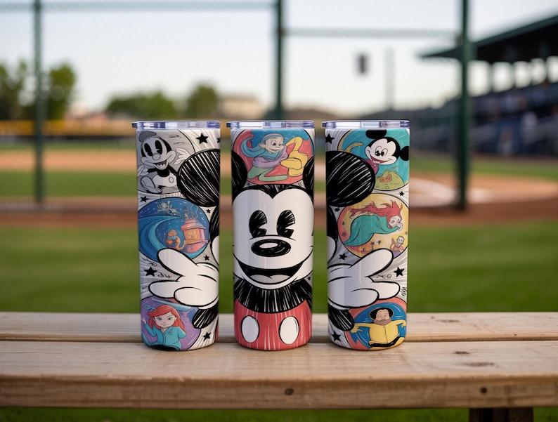 May include: Three stainless steel tumblers featuring Mickey Mouse and other Disney characters. The tumblers have a white background with colorful illustrations of Disney characters and scenes. The tumblers are cylindrical and have a silver lid.
