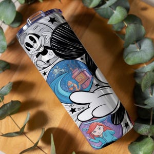May include: A stainless steel tumbler featuring a black and white Mickey Mouse design, with colorful illustrations of Disney characters. The tumbler has a silver lid and a black and white cartoon design.