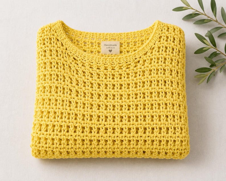Open stitch crochet sweater flat lay styling, citron yellow crochet pullover with woven bag and neutral summer accessories