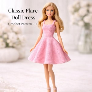 May include: A Barbie doll wearing a pink crocheted dress with a flared skirt and spaghetti straps. The text "Classic Flare Doll Dress Crochet Pattern PDF" is displayed in the upper left corner. The doll has blonde hair and is wearing pink heels.