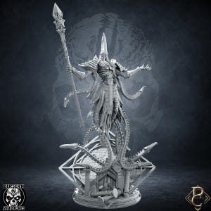 May include: A grey resin miniature figure of a skeletal entity with a pointed head, wearing ornate armour and robes. The figure holds a tall staff with a crystal tip and is surrounded by long, segmented tentacles emerging from a stone base.