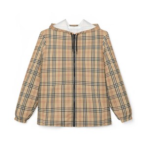May include: A tan, black, and red plaid hooded jacket with a black zipper. The jacket has long sleeves and a white interior lining in the hood. The jacket is a classic outerwear piece.