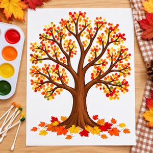 May include: A white paper featuring a brown tree trunk with branches filled with red, orange, and yellow circular paint dabs representing leaves. Fallen autumn leaves in red and yellow are painted at the base of the tree trunk.