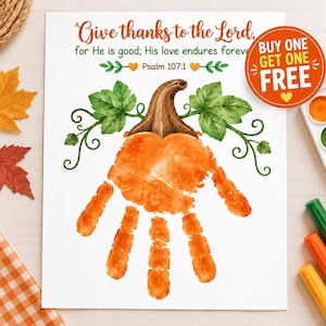 May include: A white paper print featuring a handprint painted in orange to resemble a pumpkin with a brown stem and green leaves. The text reads: Give thanks to the Lord, for He is good; His love endures forever. Psalm 107:1. A circular orange sticker says BUY ONE GET ONE FREE.
