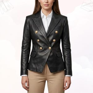 Woman wearing a glamorous black leather blazer for a professional look.