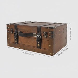 May include: A rectangular wooden trunk with a dark brown finish, black leather straps, and metal hardware. The trunk measures 13.5 inches long, 9.53 inches wide, and 6.02 inches high. It features a handle and decorative metal studs.