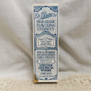 May include: Vintage Dr. Blumer's High Grade Flavoring Extracts box. The box is rectangular with a blue and white design, featuring text about the product's ingredients and use for flavoring ice cream, jellies, cakes, and pies. The box contains 4 oz.