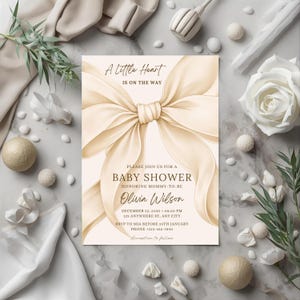 Editable baby shower invitation Canva template beige aesthetic ribbon style invite
