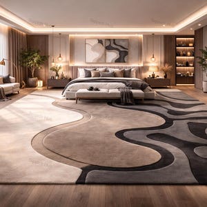 May include: A luxurious bedroom featuring a large, patterned area rug in shades of beige, gray, and black. The room includes a king-size bed, a fireplace, and a seating area. The decor is modern and elegant, with soft lighting and neutral tones.