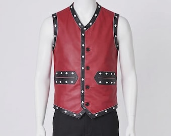 May include: A red leather vest with black trim and diamond-shaped white accents. The vest has a V-neck, three buttons, and two pockets. The vest is displayed on a mannequin.